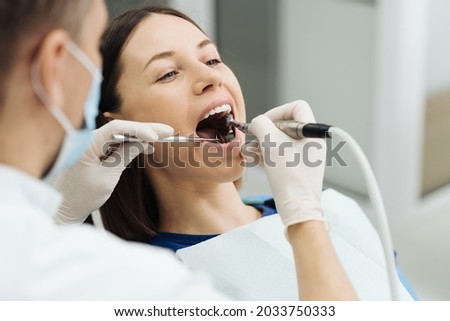 Overview of dental caries prevention. Girl at the dentist chair during a dental scaling procedure. Healthy Smile. Royalty-Free Stock Photo #2033750333