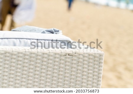 White sofa corner with cushions on the beach.