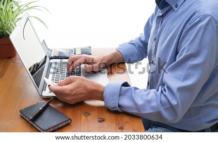 Man making online payments in front of the computer.