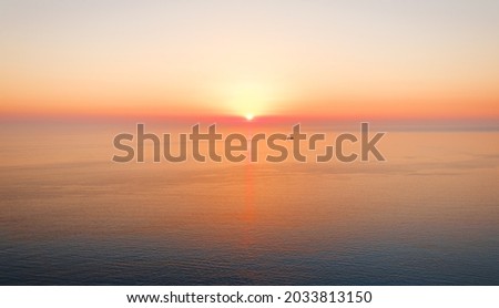 Endless tranquil seascape with beautiful sunset over horizon