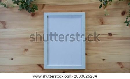 White frame on a wooden table.