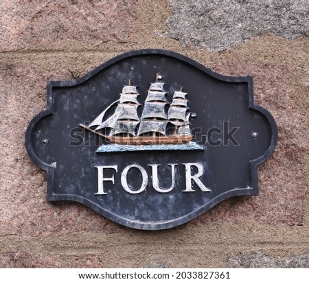 House number plaque with a sailing boat on it