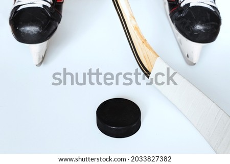 Hockey concept - skates stick and puck - winter playing sports