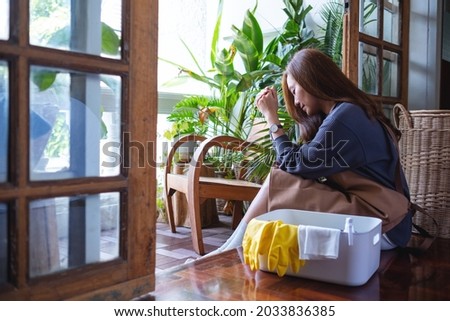 A young woman get tired while cleaning house