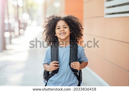 happy boy on the way back to school Royalty-Free Stock Photo #2033836418