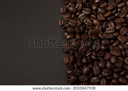 A lot of roasted coffee grains scattered on the the half of the screen