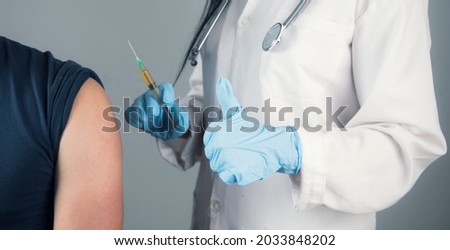 a doctor vaccinates a young guy