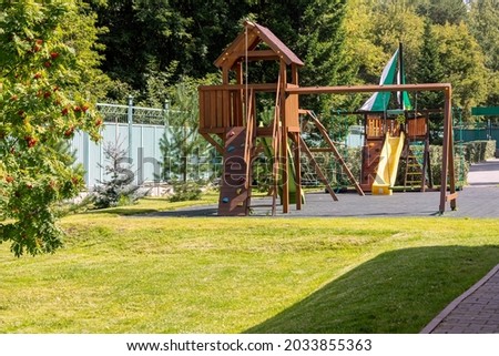 Empty playground for children for leisure and recreation with a toy in the park as a child in a natural style. Playground in a swing for mom and baby