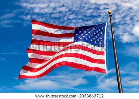 USA flag waving in clear blue sky