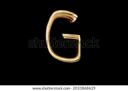 Letter G. Light painting alphabet. Long exposure photography. Drawn letter G with gold lights against black background.