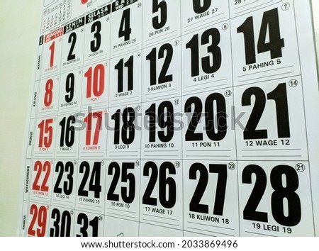 a calendar hanging on the wall.