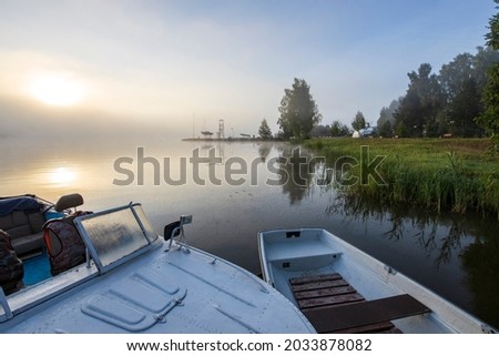 Early morning. Fog on the river. Beautiful sunrise in the summer by the river. boats at the pier.