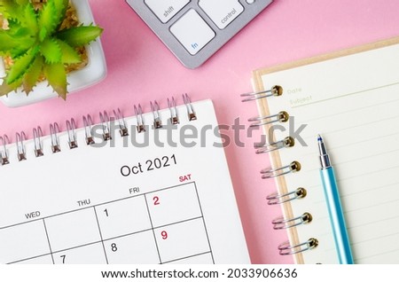 October 2021 desk calendar with keyboard computer on pink background. Royalty-Free Stock Photo #2033906636