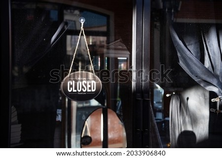 The snap shot photo of Thai restaurant exterior which hanging close sign and badge both in English and Thai language for close status. The food service economic in Thailand got effect from COVID-19.