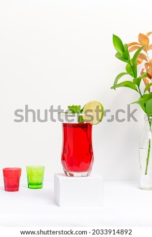 red cocktail glass made of vodka and sparkling wine on white background