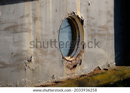 Porthole in a rusted hulk of a ship
 Royalty-Free Stock Photo #2033936258