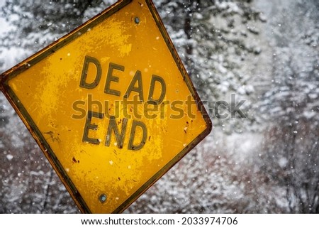 An old Dead End on a snowy rural road in Bailey, Colorado during the middle of winter.