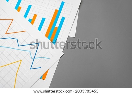Business graph analysis documents on gray background