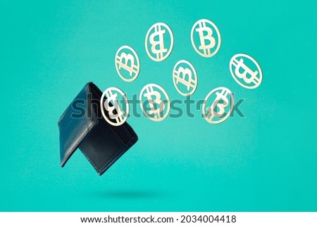 Bitcoin wallet close-up with gold coins against turquoise blue-green background. Bitcoin mining business and virtual cryptocurrency concept. Metal coins in black leather wallet. Abstract 3D Background