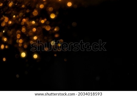 glitter vintage lights background. gold and black. de focused	