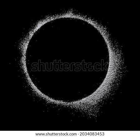 powdered sugar scattered in a round close-up isolated on black background top view Royalty-Free Stock Photo #2034083453