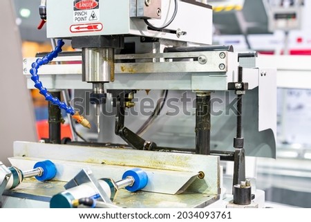 automatic copy router machine for cutting slots from profile onto windows or door wood plastic upvc aluminum etc. in industrial manufacturing process Royalty-Free Stock Photo #2034093761