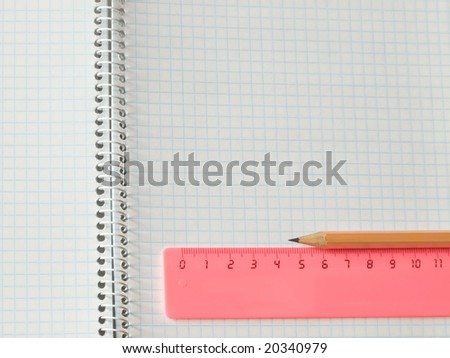 ruler and pencil on squared sheet of a copybook