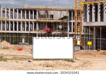 Blank white advertising banner on the construction cite fence