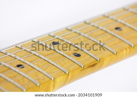 Guitar frets, markers, strings and black dots on white background Royalty-Free Stock Photo #2034101909