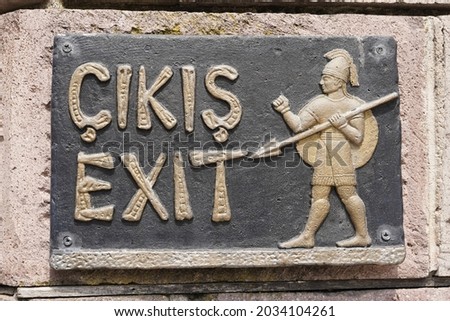 Sign "Exit" in the English and Turkish languages ​​in the old style