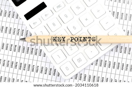 text KEY POINTS on wooden pencil on the calculator with chart