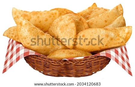 Fried pastry in wicker basket with checkered tablecloth decorating on white background for clipping.