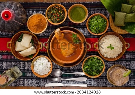 "Kak ik" traditional Guatemalan dish, made with turkey, tomato and many aromatic herbs, served with white rice and small tamales. Royalty-Free Stock Photo #2034124028