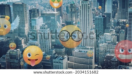 Image of emoji icons flying up over cityscape. global social media, networking and online technology concept digitally generated image.