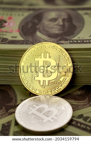 Different colors cryptocurrency coins symbol over a pile of dollar banknotes. Idea for blockchain, the new type of money in the economy of the business world.