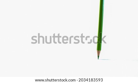 Green colored pencils are placed on a white background. Ideas for school, office, packaging and advertising.