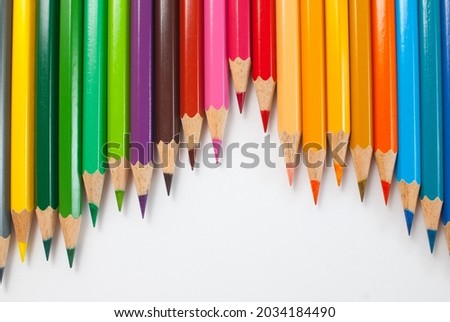 Colored pencils. Various colors are placed alternately on a white background. Ready to use in school materials, office, packaging, and advertising.