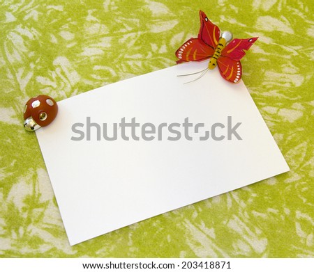 Greeting card with butterfly and ladybug in green background