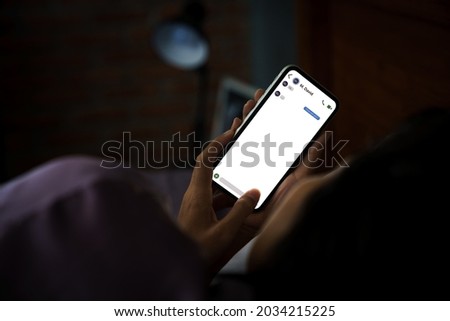women using phone texting social on bed at night