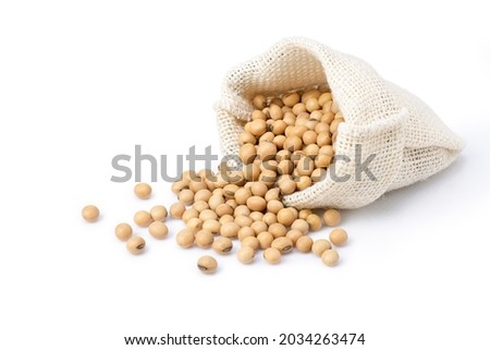 Soybeans in sack bag isolated on white background. Royalty-Free Stock Photo #2034263474