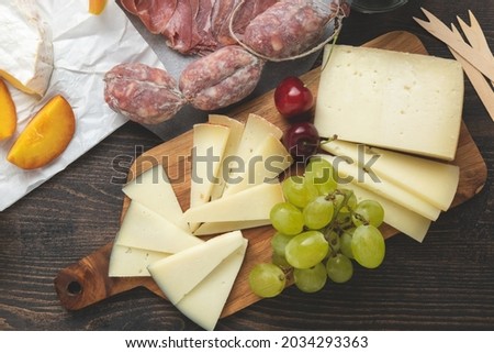 Italian cheese parmesan, pecorino and berries, Cheese Board. Top view.
