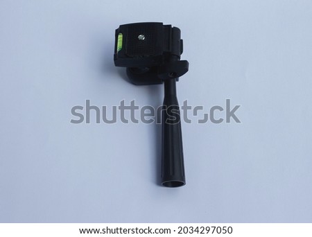 close up of tilted tripod head on white background.