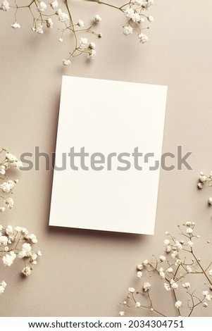 Wedding invitation or greeting card mockup with gypsophila plant twigs, stylish top view mockup with copy space