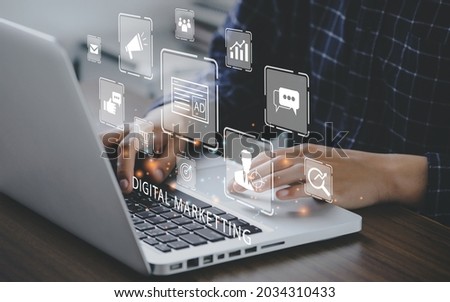 Marketer using a computer to digital online marketing banner web icon for business and social media marketing, content marketing, viral, SEO, keyword, advertise, website, and internet marketing. Royalty-Free Stock Photo #2034310433