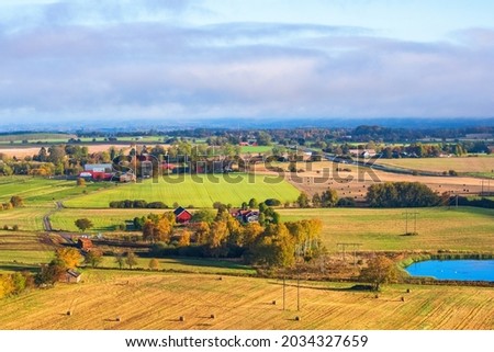Aerial view at a the countryside with autumn colours Royalty-Free Stock Photo #2034327659