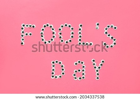 Text FOOL'S DAY on color background
