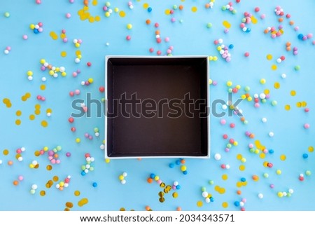 Empty box on colorful blue background, decoration for festive birthday, holiday and party time