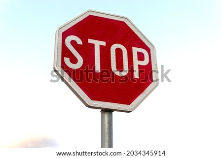 A traffic sign, Stop sign cloudy weather background.
