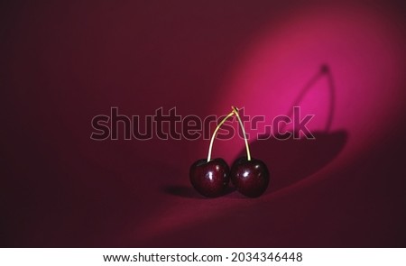 cherry on a red background, suitable for advertising cosmetics and food products