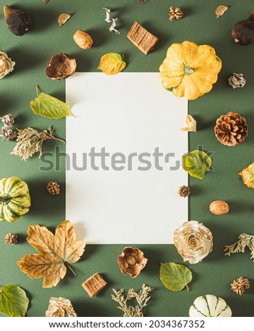 Creative layout made of natural autumn things with paper card note. Flat lay. Nature concept.